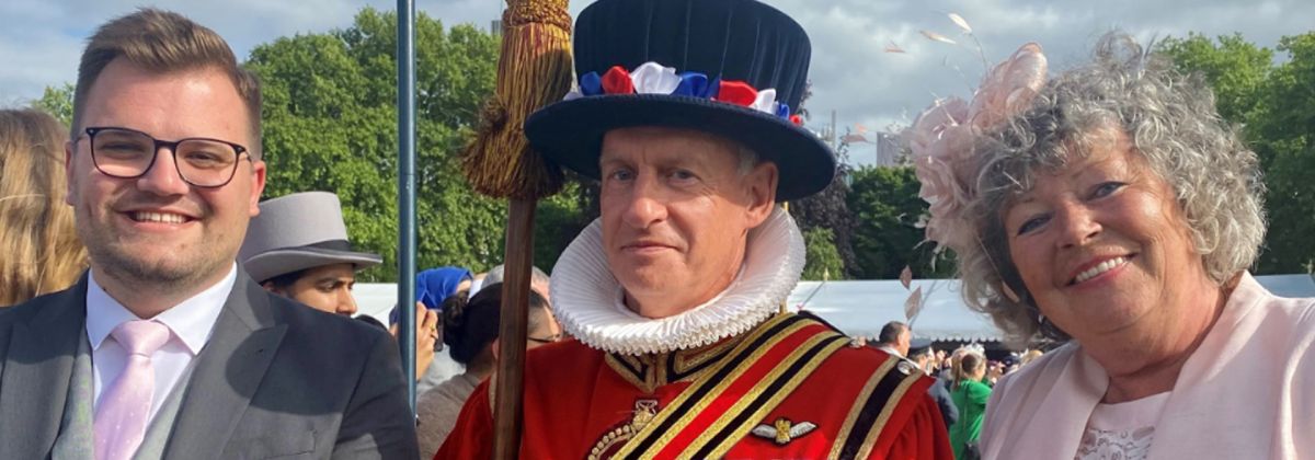 (Left to right) Liam Mills and Julia Newton with palace guard at garden party