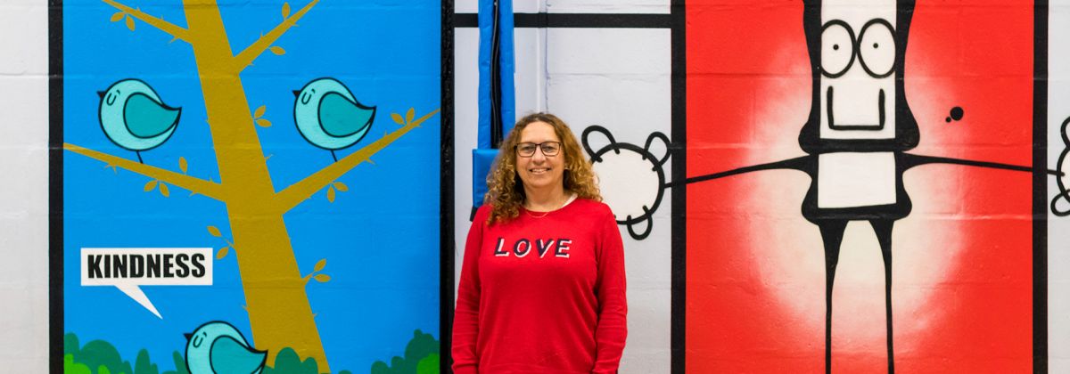 Cllr Suzy Horton in front of the mural