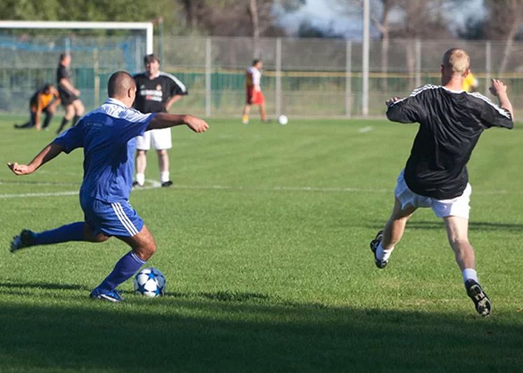 Adults playing competitive football